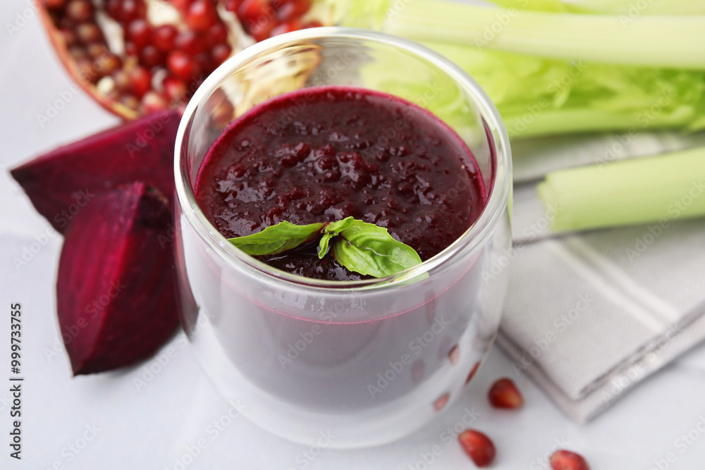 Fresh beetroot smoothie with mint in glass on white table, closeup Fresh beetroot smoothie with mint in glass on white table, closeup