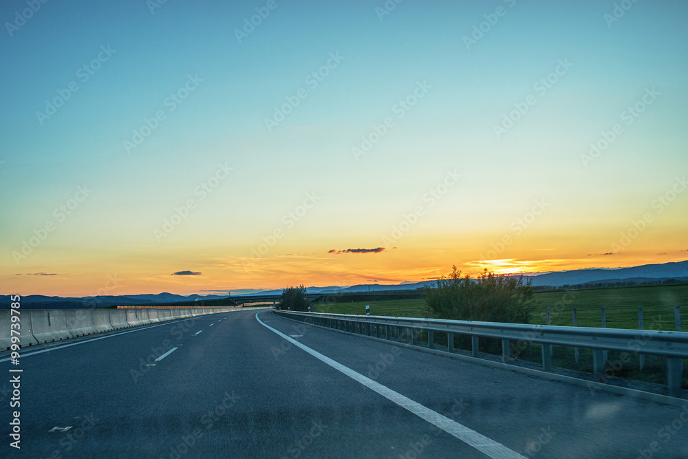 Fototapeta premium View of the highway from car during sunset.