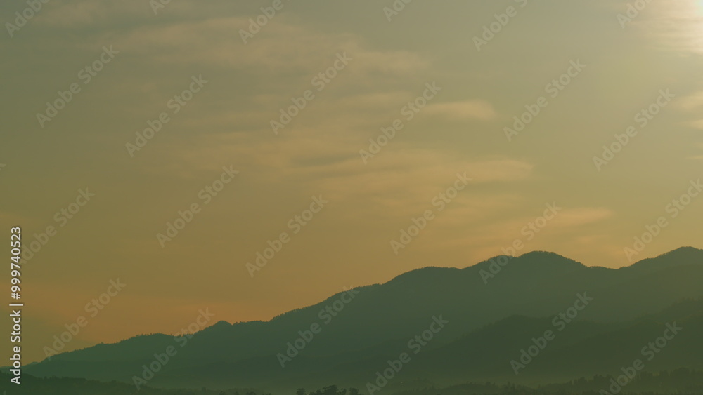 Obraz premium Beautiful Golden Sunrise. Silhouette Of The Mountain Hills Against Sunrise Sky. Real time.