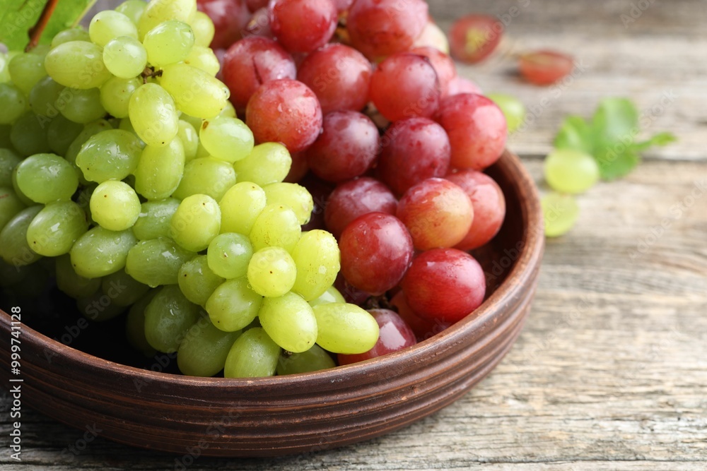 Fresh ripe grapes on wooden table, closeup Fresh ripe grapes on wooden table, closeup