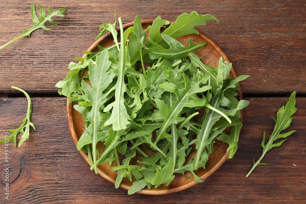 Fresh green arugula leaves on wooden table, top view Fresh green arugula leaves on wooden table, top view