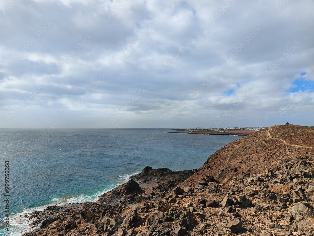 Costa Teguise seascape with mountains and dramatic skies Lanzarote Spain Costa Teguise seascape with mountains and dramatic skies Lanzarote Spain