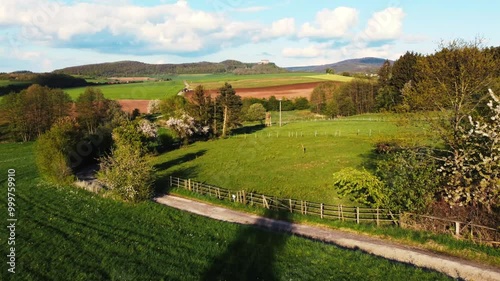 A breathtaking aerial view of rural USA in springtime, showcasing lush meadows, forests, and agricultural fields under a vibrant sky. Idyllic, peaceful, and full of natural beauty.