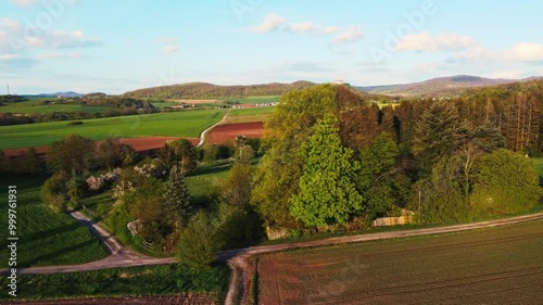A breathtaking aerial view of rural USA in springtime, showcasing lush meadows, forests, and agricultural fields under a vibrant sky. Idyllic, peaceful, and full of natural beauty.
