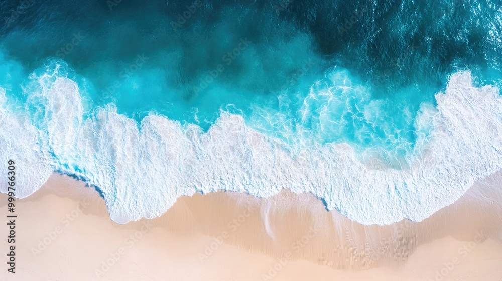 Aerial view of ocean waves crashing onto a sandy beach, showcasing vibrant blue and white colors. Aerial view of ocean waves crashing onto a sandy beach, showcasing vibrant blue and white colors.