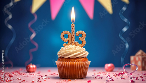 Birthday cupcake with burning lit candle with number 93. Number ninety-three for ninety-three years or ninety-third anniversary. photo