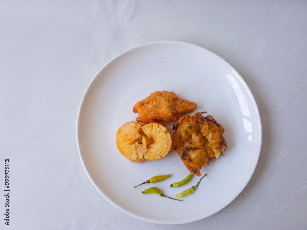 Gorengan : Fried food is one of the most popular types of snacks in Indonesia. Indonesian street food.Black background. Gorengan : Fried food is one of the most popular types of snacks in Indonesia. Indonesian street food.Black background.