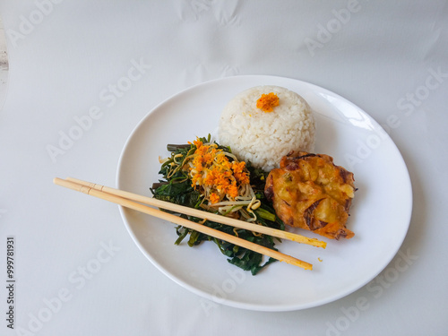 Urap Sayur. healthy and traditional indonesian food isolated on white photo