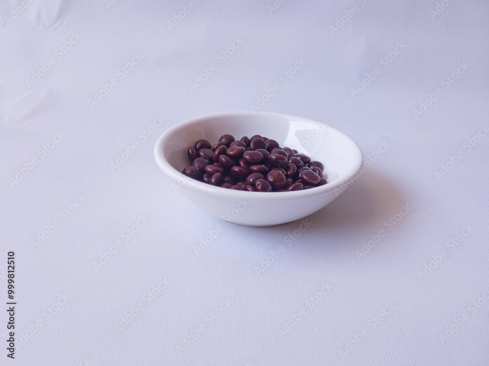 Chocolate coated peanut candy or chocolate balls isolated on white background Chocolate coated peanut candy or chocolate balls isolated on white background