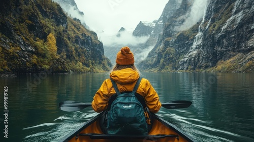 view from behind a girl in a canoe gliding through serene waters surrounded by dramatic fjords evoking a sense of adventure and connection with nature