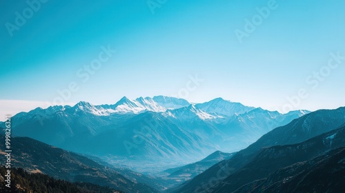 Snow-capped mountains against a bright blue sky serving as a dramatic background