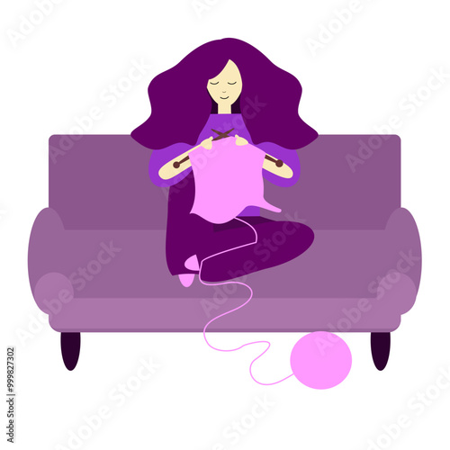 A girl or young woman is knitting sitting on the sofa 