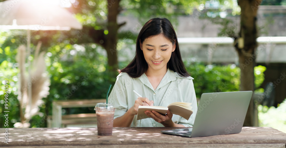 Asian business woman working outside creative notes ideas innovation, using laptop computer portable device wireless remote technology, digital online freelance worker outdoor sitting at cafe sunlight Asian business woman working outside creative notes ideas innovation, using laptop computer portable device wireless remote technology, digital online freelance worker outdoor sitting at cafe sunlight