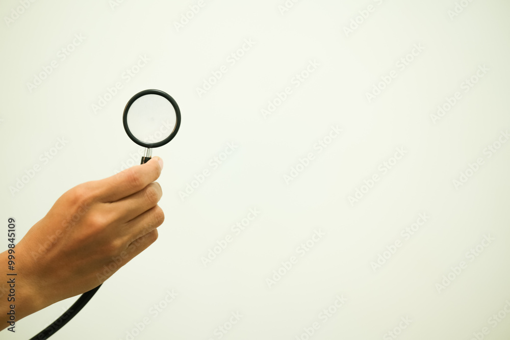 Doctor's Hand Holding Stethoscope, Isolated on White background Doctor's Hand Holding Stethoscope, Isolated on White background