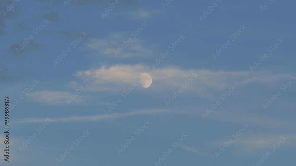 close up view of the moon during the day,full moon view of the moon on a blue and cloudy day, close up view of the moon during the day,full moon view of the moon on a blue and cloudy day,