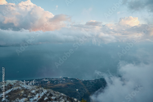 Serene Ocean View from a Majestic Mountain Summit with Fluffy Clouds in the Sky