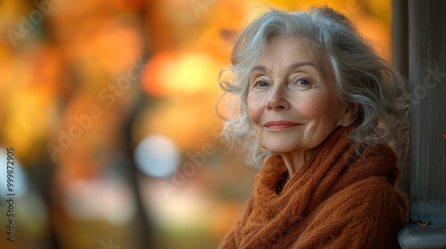 an elderly woman sitting outdoors on a terrace on a sunny day in autumn