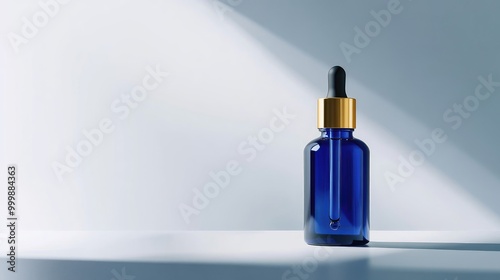 Luxurious blue glass serum bottle with a gold dropper, standing out against a clean background. No people. No logo.