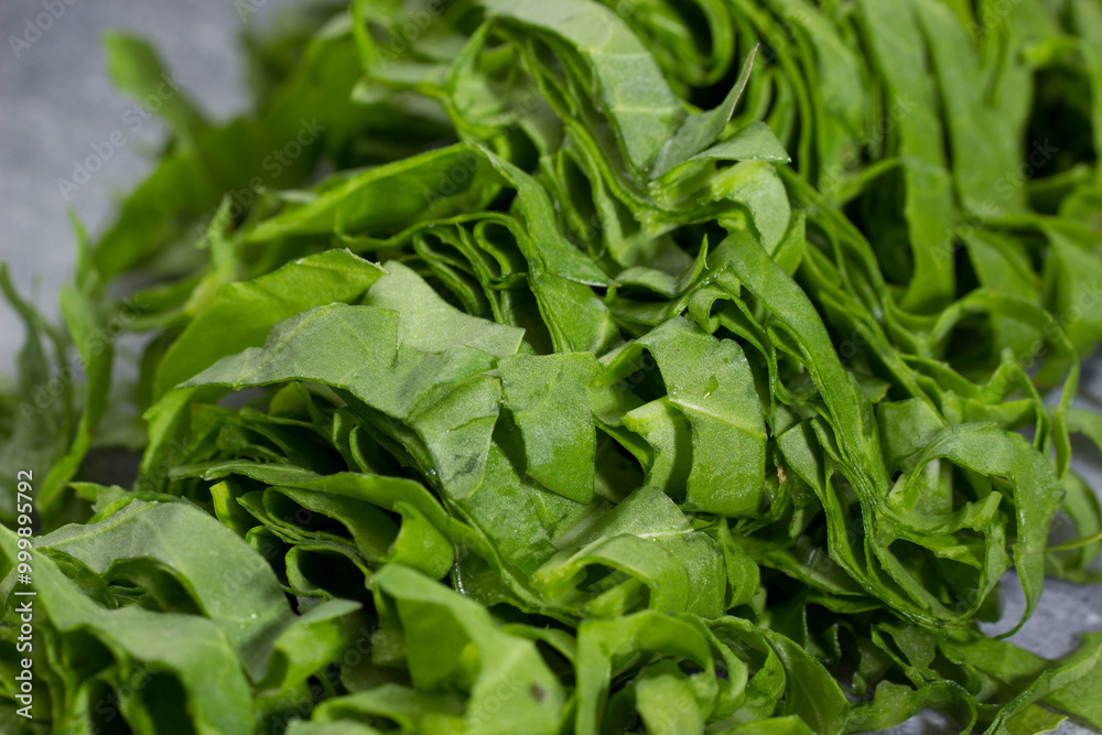 freshly sliced sorrel lies with a knife on a cutting board. close-up freshly sliced sorrel lies with a knife on a cutting board. close-up