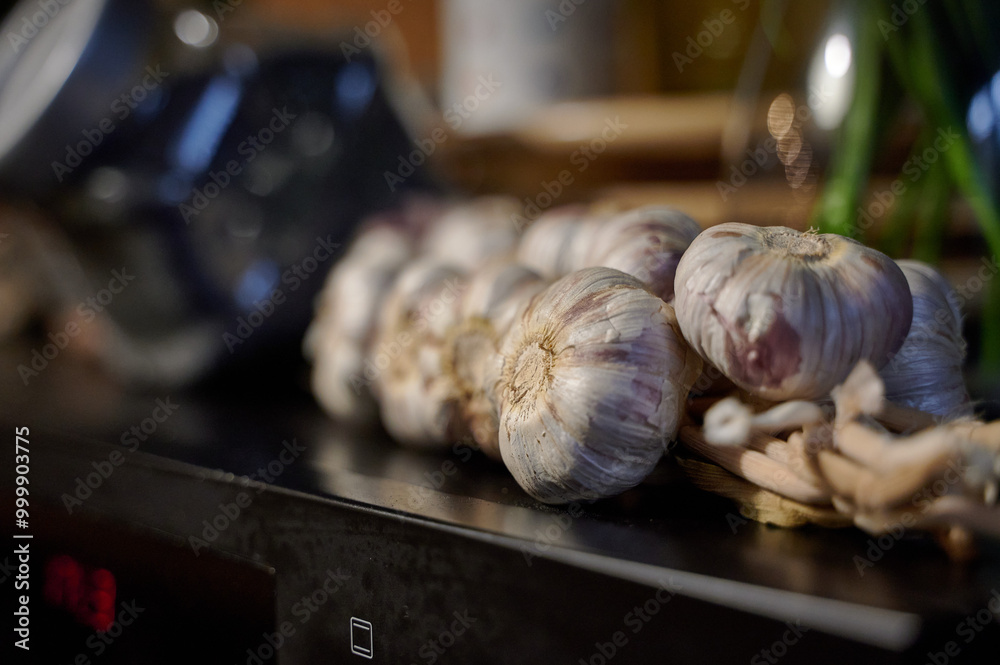 Rustic Garlic Display on Kitchen Counter in Warm, Ambient Light, Ready for Meal Preparation