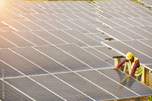 Portrait of an engineer working on solar panels at a solar powered station, Thailand photo