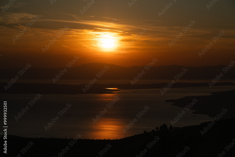 Obraz premium The sunset bathes the Croatian Adriatic coast in orange color.