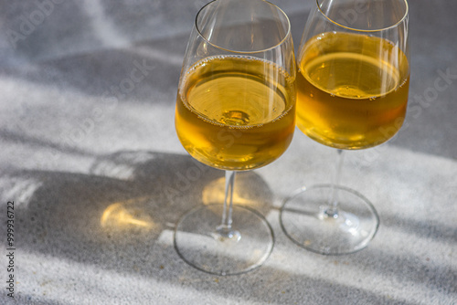 Close-up of two glasses of Traditional Georgian Kisi white wine on a table in sunlight photo