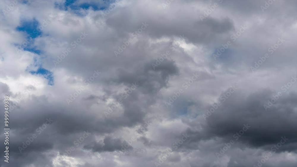 Time lapse of black clouds. The sky is cloudy and gray with black clouds scattered everywhere. The scene is dark and somewhat gloomy. Time lapse of black clouds. The sky is cloudy and gray with black clouds scattered everywhere. The scene is dark and somewhat gloomy.