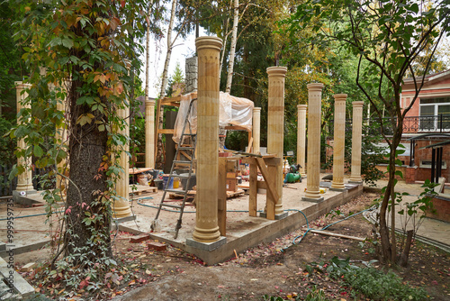 building a summer pergola with columns in the garden photo