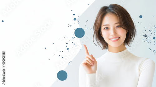 portrait of a young Japanese woman in her late 30s with short hair, wearing a white, smiling and pointing with her index finger on a plain background.
