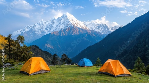 A mountain campsite with tents pitched near a forest edge with a breathtaking view of snow-capped peaks in the distance