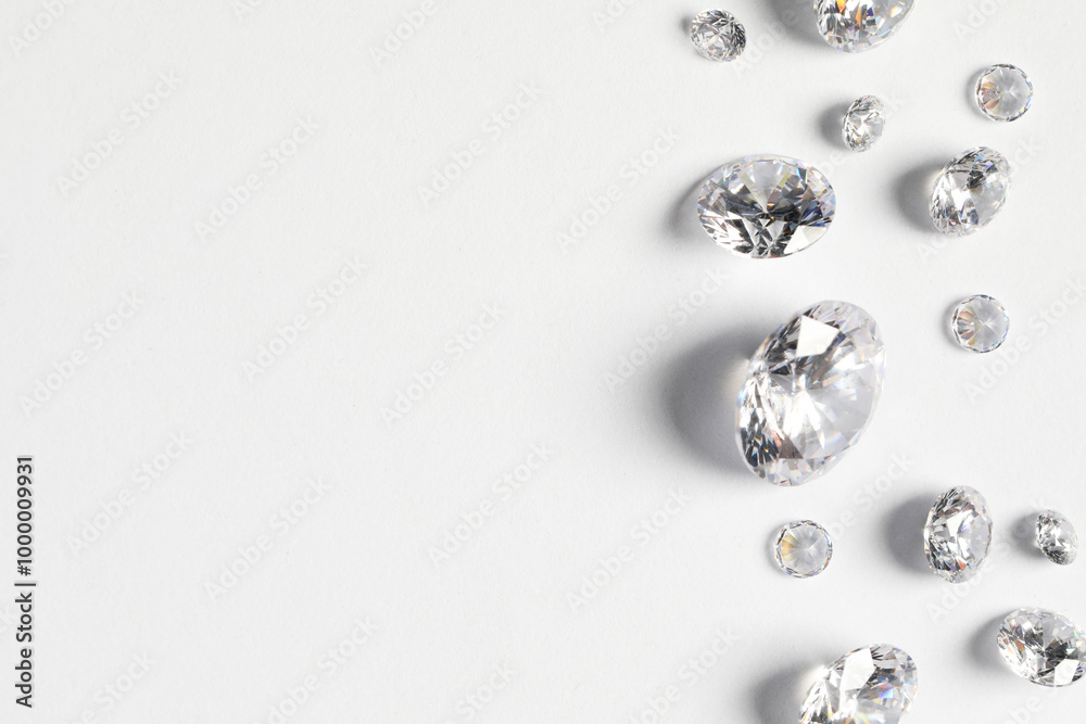 Many beautiful shiny diamonds on white background, flat lay. Space for text Many beautiful shiny diamonds on white background, flat lay. Space for text