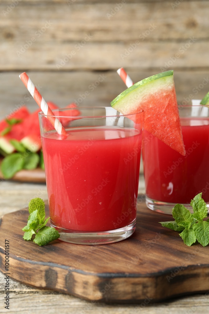 Tasty watermelon drink in glasses, fresh fruit and mint on wooden table, closeup Tasty watermelon drink in glasses, fresh fruit and mint on wooden table, closeup