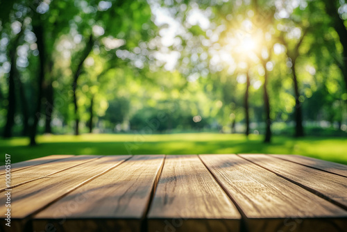 Empty wooden table top with a blurred green park background for product display montage, a summer concept. 