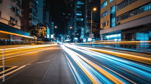 Bright light trails from passing cars illuminate the street in a bustling city during the night, showcasing the dynamic energy of urban life