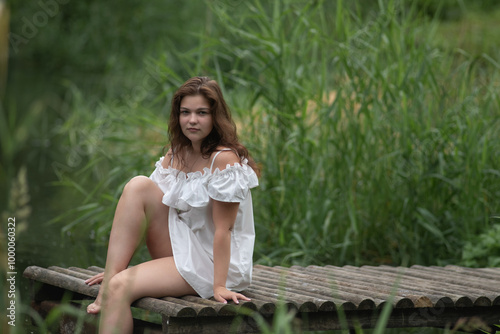 Beautiful young dark-haired girl by the river.