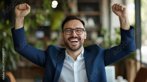 A man celebrating his success at a modern office during a bright afternoon