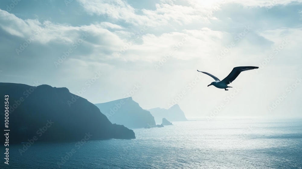 A serene landscape featuring a bird soaring over a tranquil sea and distant mountains. A serene landscape featuring a bird soaring over a tranquil sea and distant mountains.