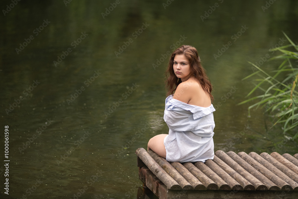 Beautiful young dark-haired girl by the river. Beautiful young dark-haired girl by the river.