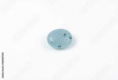 Small smooth pebble with a light aqua blue color and a transluce