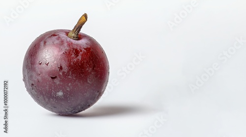 A small red apple with a stem on top. The red grapes is covered in frost and he is frozen