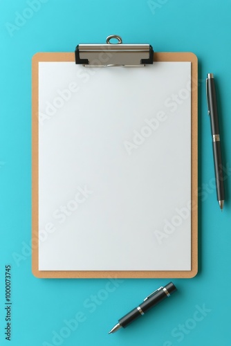 Blank clipboard and pens on a turquoise background for creative note-taking