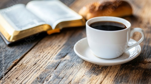 Enjoying a warm cup of coffee beside an open book and pastry on a rustic wooden table