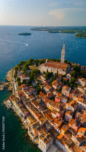 Aerial view of Rovinj, Croatia showcasing colorful homes along the coastline at sunset
