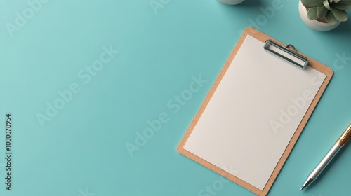 Blank clipboard and pen on blue background, ready for notes and organizationa...