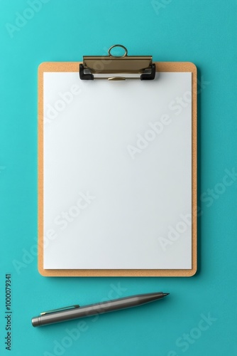 A blank clipboard and pens resting on a vibrant turquoise background for crea...