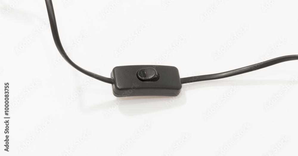 Black inline rocker switch on cable, isolated against white background, suitable for electronic device controls. Black inline rocker switch on cable, isolated against white background, suitable for electronic device controls.
