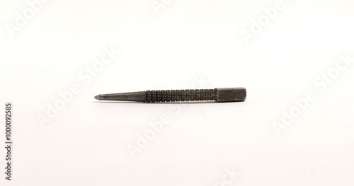 Small metal center punch tool with textured grip, used for marking metal or woodworking.