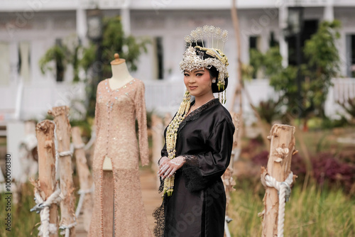 The bride's preparation is complete, with her makeup ready for a traditional Sundanese wedding from West Java. In the background, the kebaya she will wear and the picturesque view of rice fields and a