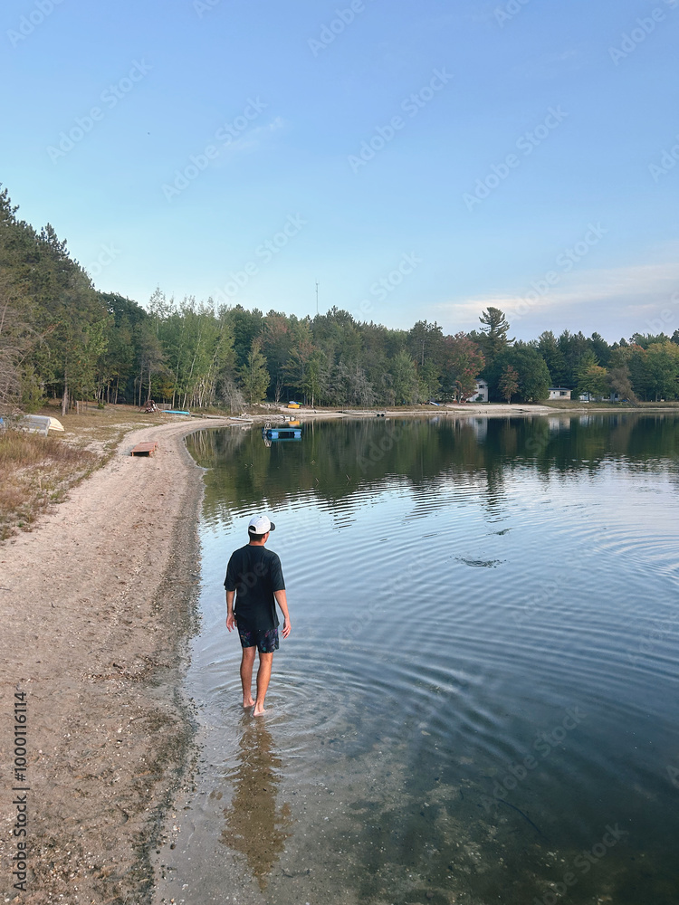 man walking by the lake in the woods man walking by the lake in the woods